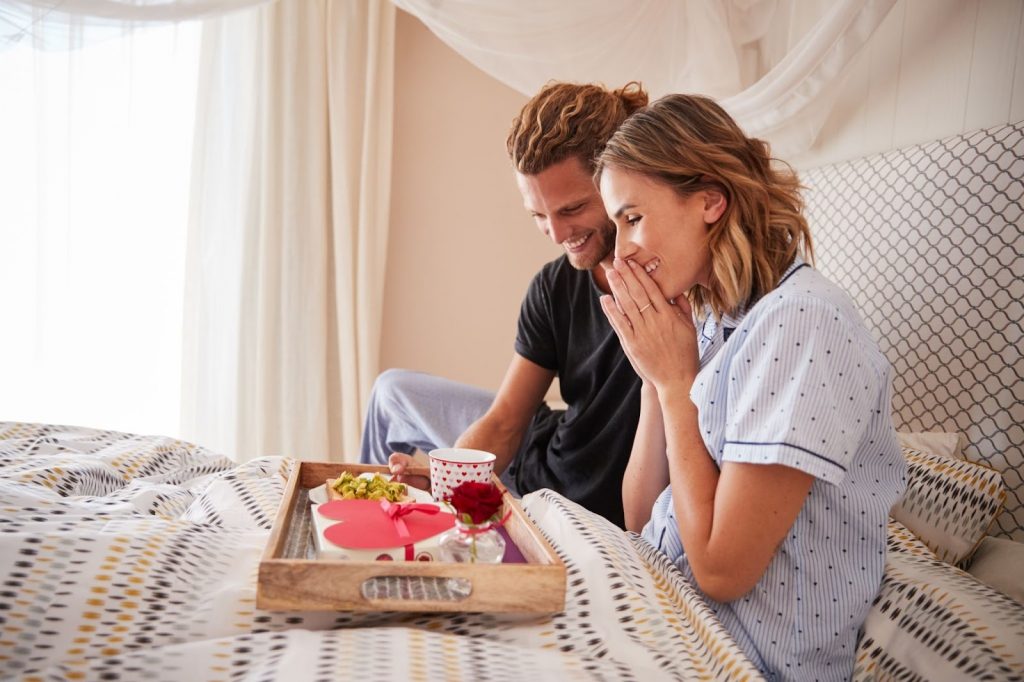 Couple Having Breakfast In The Bed