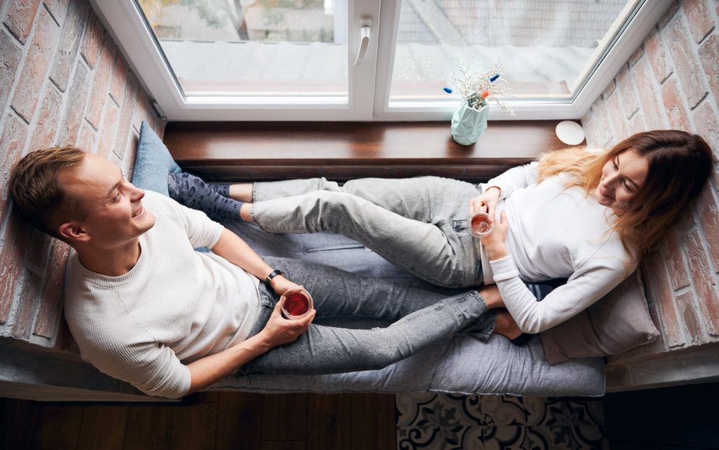 Happy Young Couple Drinking Tea At Home