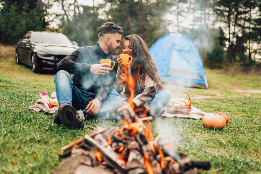 Romantic Couple Sitting Near Campfire