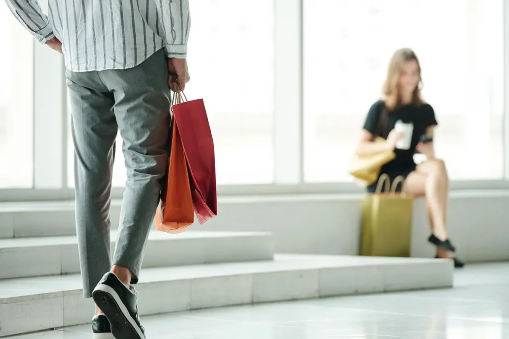 cropped man carrying a red bag